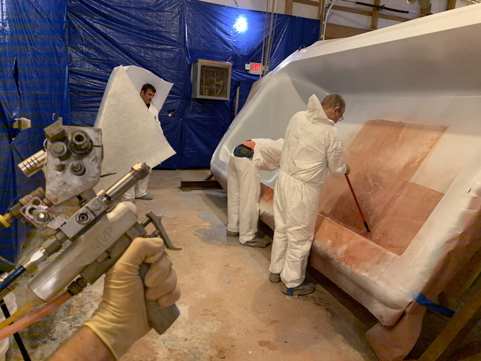 crew of people working on a fiberglass project